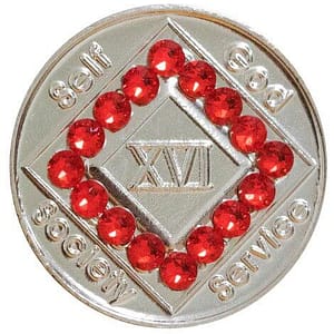 A silver coin with red beads around it.
