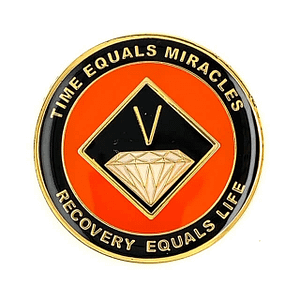 A red and black pin with the words " tire equals miracles recovery equals life ".