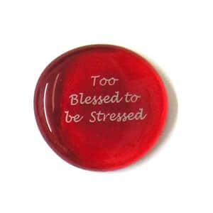A red glass circle with the words " too blessed to be stressed ".