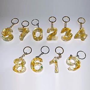 A group of eight keychains that are made to look like numbers.