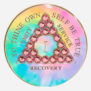 With a soft, dreamy aesthetic, this AA Crystal Medallion features a hand-painted pastel tie-dye design in a delicate light rose hue, accented with shimmering Swarovski crystals, symbolizing self-love and new beginnings in recovery.