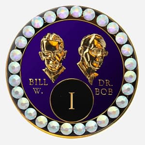 Purple AA medallion with crystal AB accents, featuring stylized busts of Bill W. and Dr. Bob, commemorating sobriety.