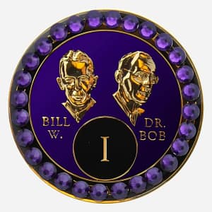 Purple AA medallion with crystal AB accents, featuring stylized busts of Bill W. and Dr. Bob, commemorating sobriety.