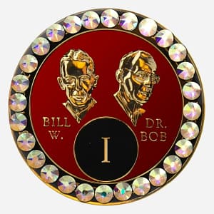 A red crystal AA medallion with crystal AB accents, featuring stylized busts of Bill W. and Dr. Bob.