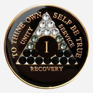 A black crystal AA medallion with a subtle black transition design using 21 crystals, featuring the AA symbol and sobriety year options.