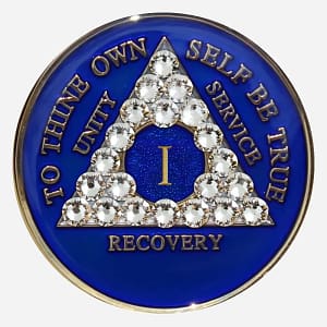 A blue crystal AA medallion with diamond accents, featuring the AA symbol and sobriety year options.