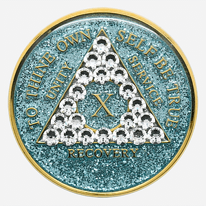 A glitter aqua crystal AA medallion with diamond crystal accents, featuring the AA symbol and sobriety year options.