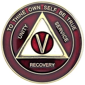 A red and gold coin with the words recovery written on it.