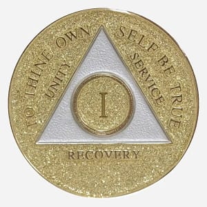 Gold glitter AA medallion with the AA symbol and 'To Thine Own Self Be True' motto, representing sobriety achievements