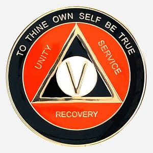 AA Alcoholics Anonymous token in black and orange with gold accents, with the AA triangle symbol and the words "Unity Service Recovery" on the outside of the triangle.