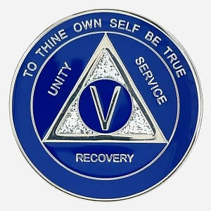 A blue and silver AA triplate token with silver glitter accents, and the words "To Thine Own Self Be True" at the top of coin, and "Unity, Service, Recovery" on the outside of an AA triangle symbol.