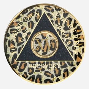 The Triplate AA Token Glitter Leopard features a bold leopard print design, symbolizing courage and resilience on your recovery journey. The iconic AA symbol and motto shine in gold.