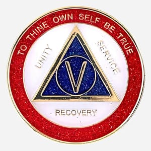 A dazzling AA sobriety medallion (approximately 34mm) with a gold-plated finish, featuring sparkling red, white, and blue enamel accents. The front prominently displays the AA circle and triangle symbol, surrounded by the words 'Unity,' 'Service,' and 'Recovery.' The outer rim is inscribed with 'To Thine Own Self Be True' and the sobriety anniversary year (in Roman numerals, 1-40 years). This token has a high-gloss, epoxy-coated finish that enhances its vibrant, glittery appearance.