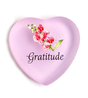 A heart shaped plate with the word gratitude written on it.