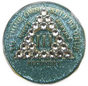 A blue coin with a diamond shaped emblem on it.