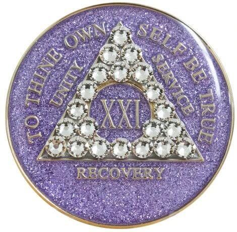 A purple glitter coin with white stones on it.