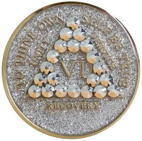 A gold and silver coin with pearls on it