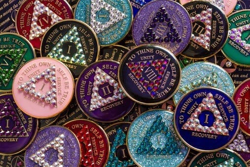 A pile of colorful coins with different designs.