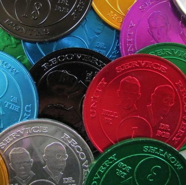 A close up of many different colored coins