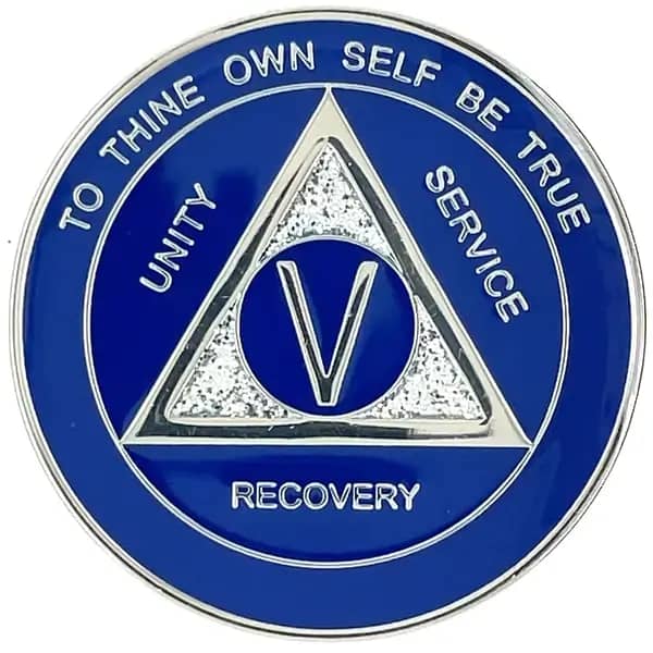 A blue and white medal with the words recovery written on it.