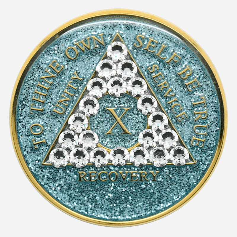 A glitter aqua crystal AA medallion with diamond crystal accents, featuring the AA symbol and sobriety year options.