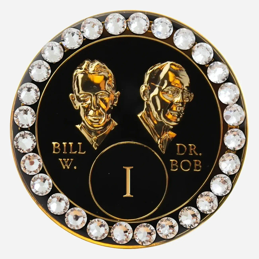 A black crystal AA medallion with diamond accents, featuring stylized busts of Bill W. and Dr. Bob.