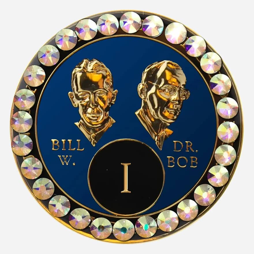 Blue AA medallion with AB crystals, featuring stylized busts of Bill W. and Dr. Bob, commemorating sobriety.