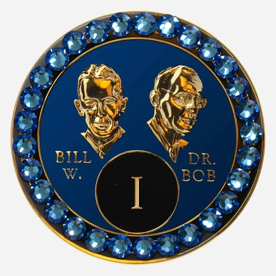 Blue AA medallion with sapphire accents, featuring stylized busts of Bill W. and Dr. Bob, commemorating sobriety.