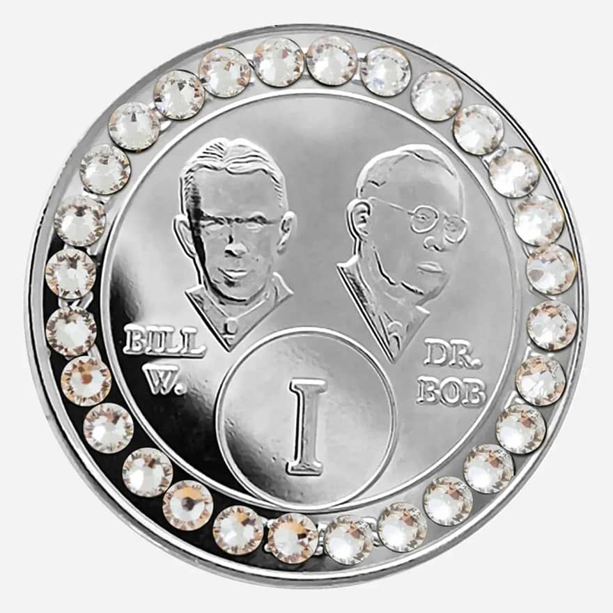 Nickel AA medallion with diamond accents, featuring stylized busts of Bill W. and Dr. Bob, commemorating sobriety.