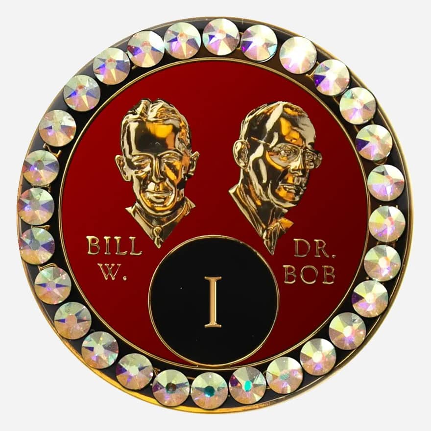 A red crystal AA medallion with crystal AB accents, featuring stylized busts of Bill W. and Dr. Bob.