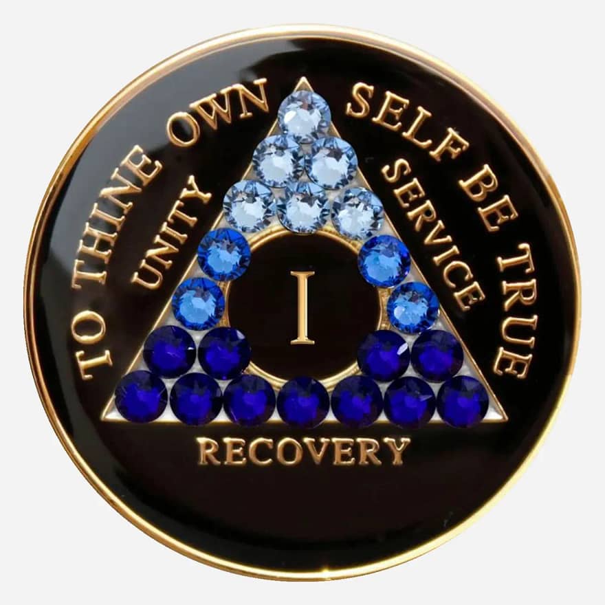 A black and blue crystal AA medallion, featuring the AA symbol and sobriety year options ranging from 1 to 50 years.