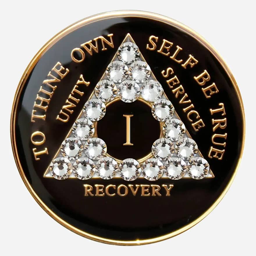 A black crystal AA medallion with diamond accents, featuring the AA symbol and sobriety year options.