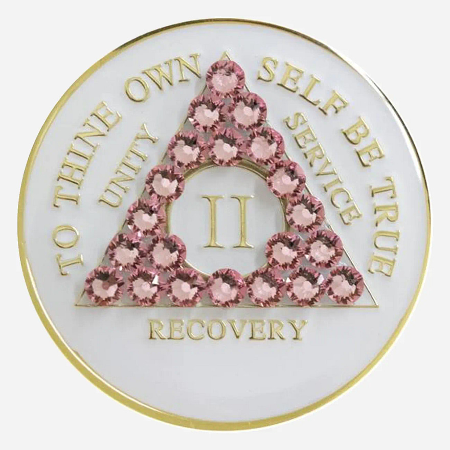 A white crystal AA medallion with light rose accents, featuring the AA symbol and sobriety year options.