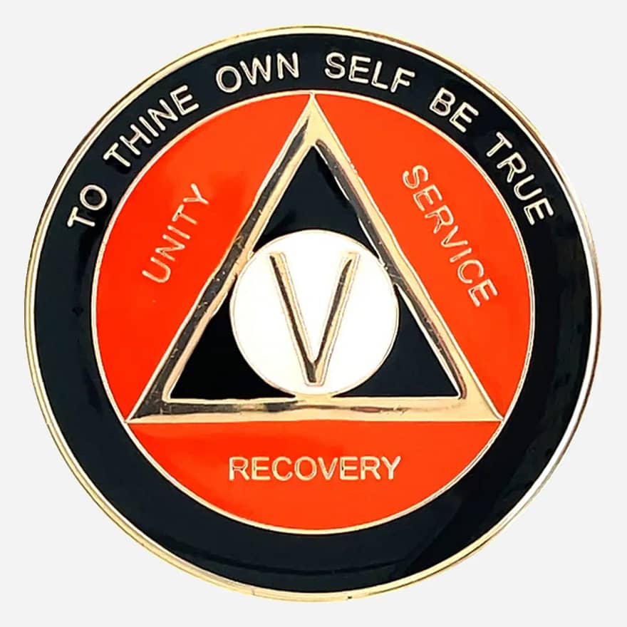 AA Alcoholics Anonymous token in black and orange with gold accents, with the AA triangle symbol and the words "Unity Service Recovery" on the outside of the triangle.