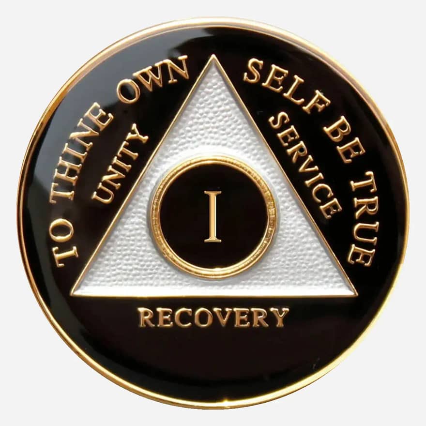 The black Triplate AA Token features the AA symbol and "To Thine Own Self Be True" motto in a crisp white, offering a stark contrast that symbolizes clarity and commitment to recovery.