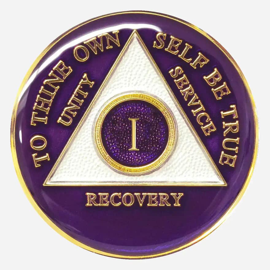 The purple Triplate AA Token features the AA symbol and motto in a contrasting white, embodying the wisdom and strength gained through the recovery journey.